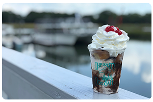 Layers of homemade Salty Dog ice cream swirled with world famous
hushpuppies and a chocolate and caramel drizzle.